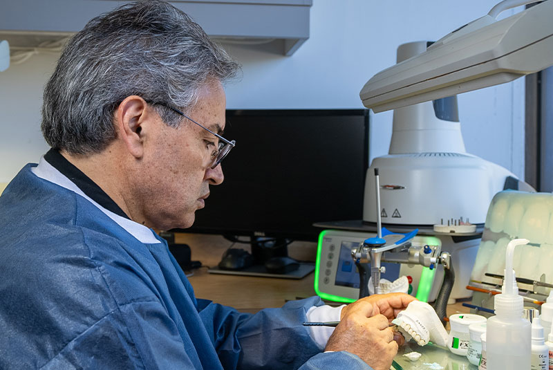 denta lab tech working on prosthetic teeth